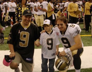 Drew Brees poses with a Hogs for Cause beneficiary