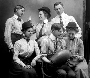 A group of young adults drinking alcohol from a jug, ca. 1900